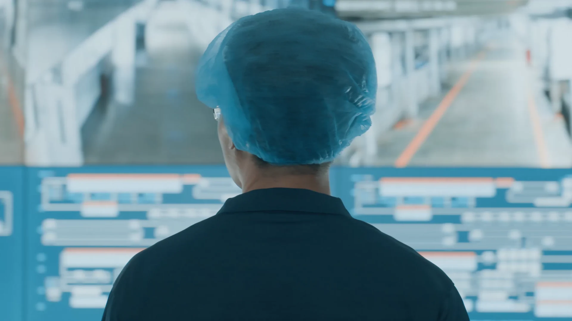 An operator viewing process-monitoring screens at a manufacturing partner facility